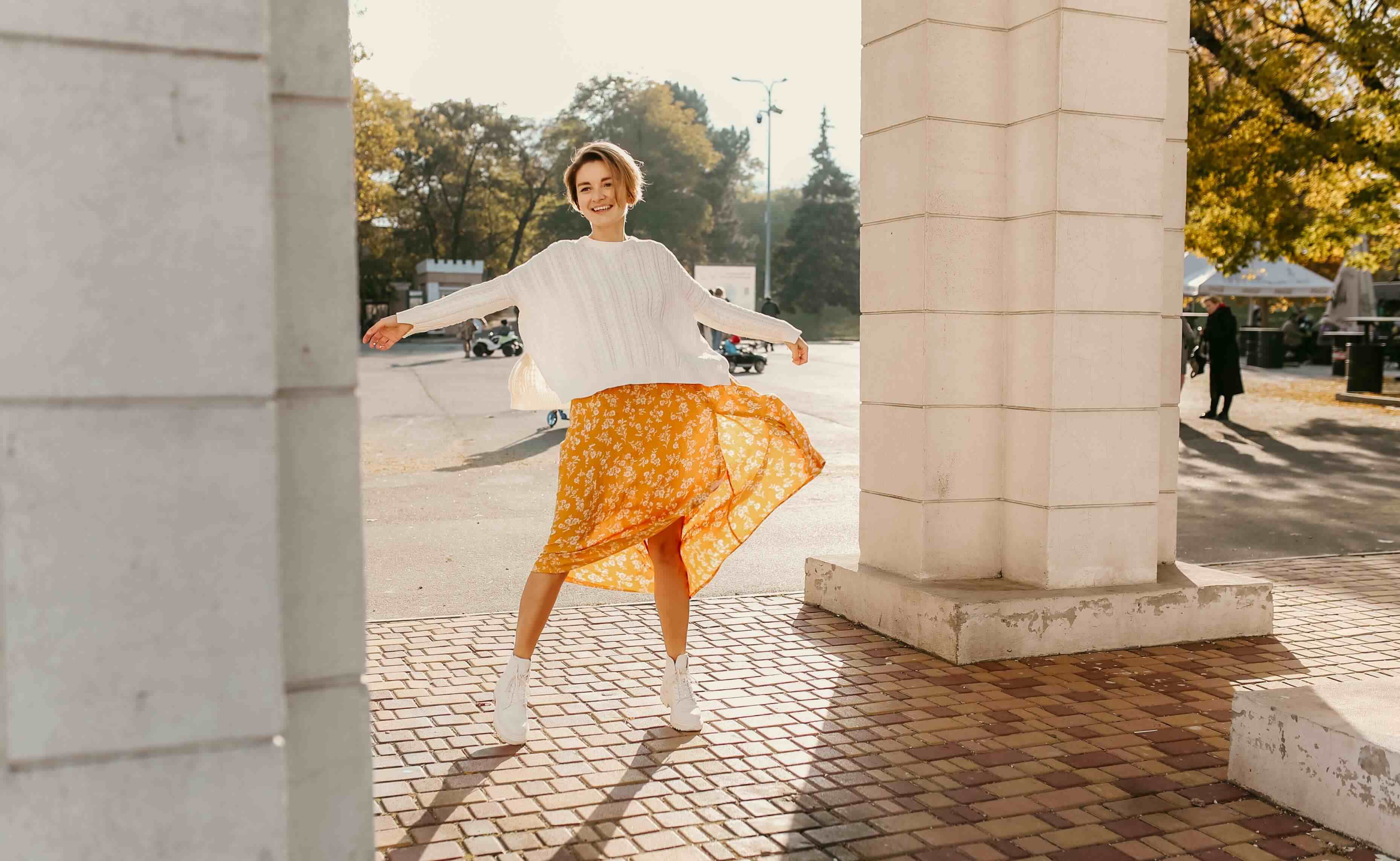 young-pretty-happy-smiling-woman-yellow-printed-dress-knitted-white-sweater_1